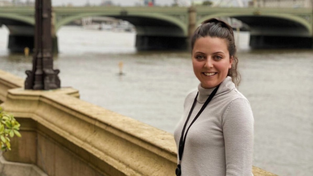 Aliya stands on the terrace outside the House of Commons, overlooking Westminster Bridge