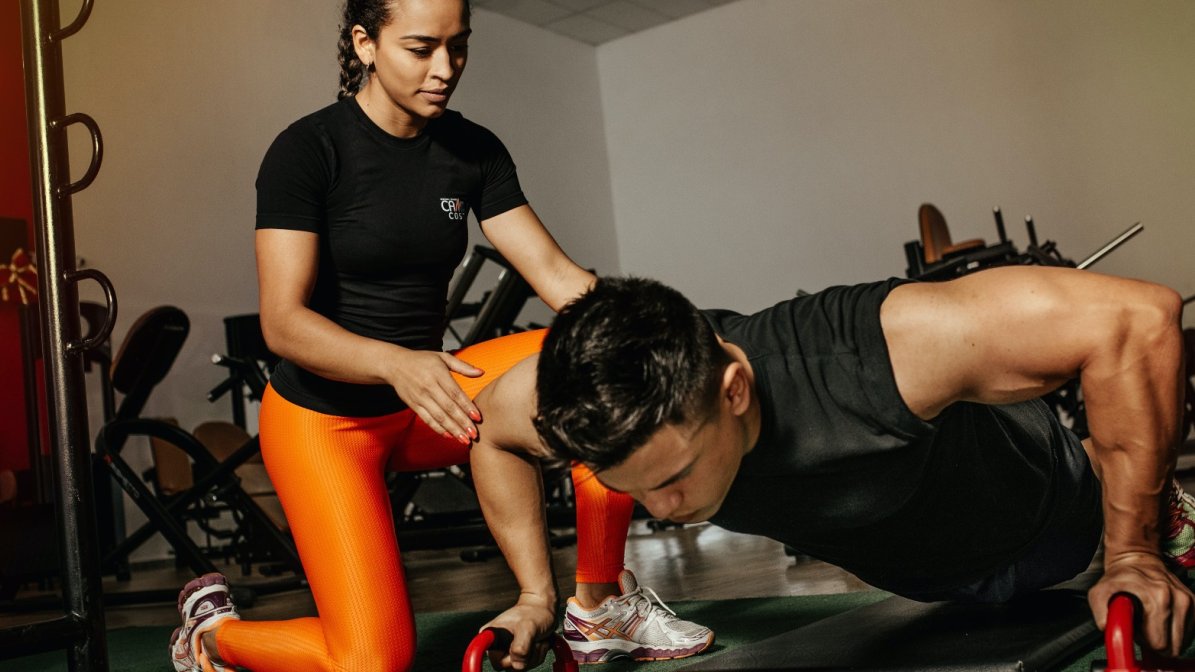 Personal trainer helping a client