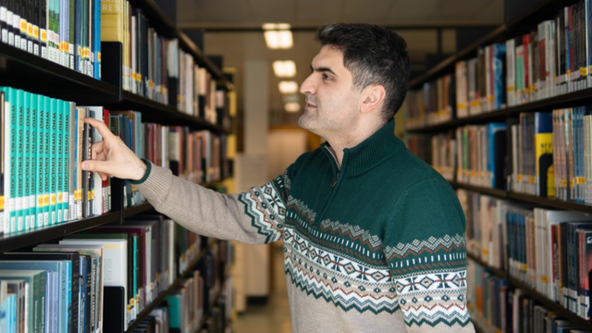 Care experienced mature student in university library  
