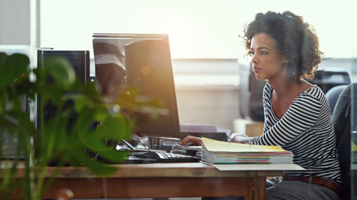 editorial assistant working at desk on computer