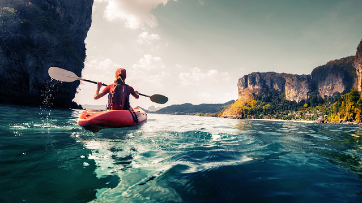 Person kayaking at sea