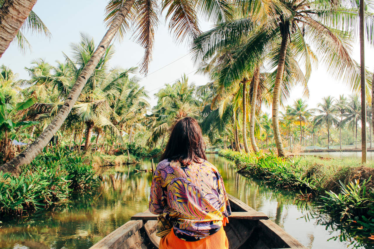 Girl on boat on tropical river 